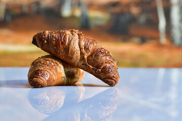 an arrangement of freshly made croissants on a table. Traditional food and abstract concept.