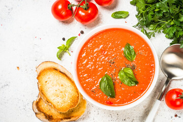 Tomato soup at white table.