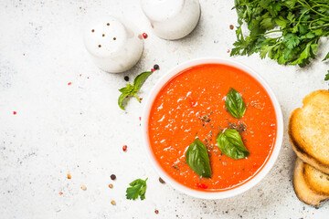 Tomato soup at white table.