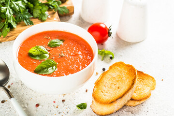 Tomato soup at white table.