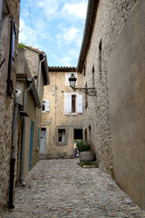 Fototapeta na wymiar The medieval stone architecture and the old narrow street of Lagrasse, the most beautiful medieval village of France, located in the picturesque mountain valley in Pyrenees
