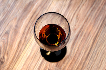 Glass of wine on a wooden background.