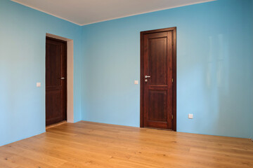 New home construction interior room with wooden floors and wooden doors
