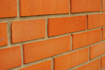 Obraz premium Orange brick wall. Perspective close up view