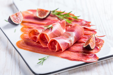 Delicious Serrano ham with fresh figs and rosemary
