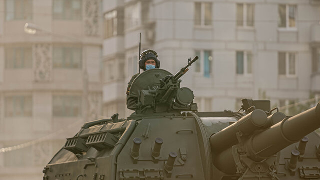 soldiers in protective mask from covid-19 in a tank during a parade rehearsal