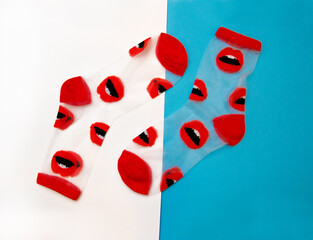 Two socks with red lips on a white and blue background. Stylish fashion clothes. Womens clothing
