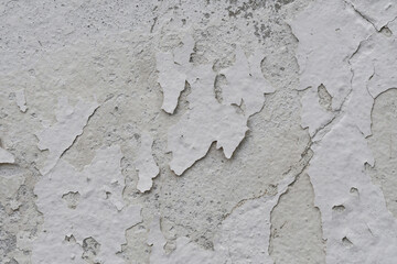 Peeling paint of white wall.Closeup of peeling painted wall.Grungy cracked white wall paint peeling off.