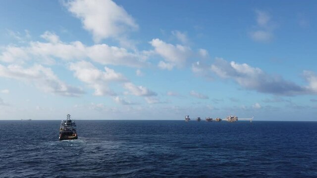 Central processing platform (cpp) in the middle of the ocean on sunny day - upstream industry
