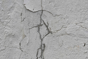 Obraz premium Peeling paint of white wall.Closeup of peeling painted wall.Grungy cracked white wall paint peeling off.