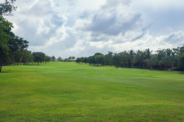 Fototapeta na wymiar Golf course in Dominican republic. field of grass and coconut palms on Seychelles island.