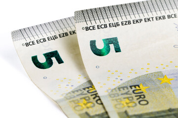 Euro banknotes of five euros on white, close-up. Money concept, small income.