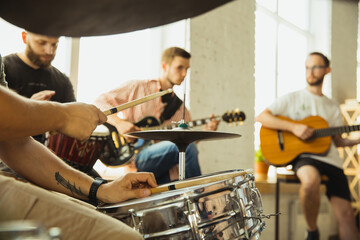 Festival. Musician band jamming together in art workplace with instruments. Caucasian men and...
