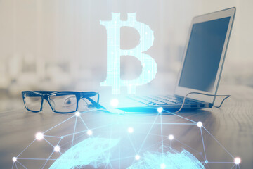 Multi exposure of blockchain theme hologram and table with computer background. Concept of bitcoin...