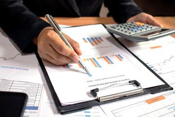 Businessmen are reviewing reports, financial documents for financial data analysis, work ideas and market data.