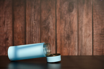 blue vacuum tumbler with the lid opened in a sunny morning