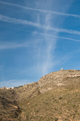 Observation tower, Santa Eulalia La Mayor village and contrails of airplanes. Guara mountains. Huesca. Aragon. Spain.