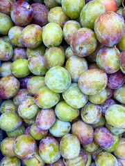 Organic healthy  plum harvest on the outside street market harvest day.  Delicious raw vegetarian nutrition