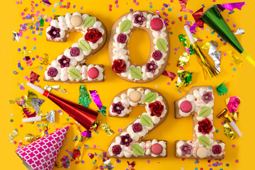 Plakat 2021 cake and ornaments isolated on yellow background. New year concept. 