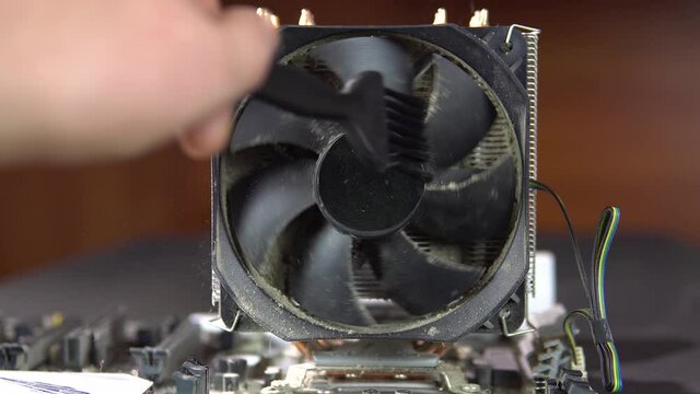 Dust pollution. Dirty cooler. Cleaning the cooler and processor heat sink from dust. Antistatic brush. 4k.