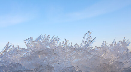 Close up ice crystals pattern over blue sky