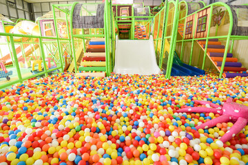 Children playground indoor at amusement park - Inside the beautiful kids playground with plastic dry pool with colorful balls for playing