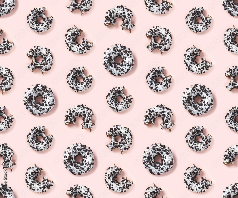 Poster quality seamless pattern of donuts on a pink background top view. flat lay of delicious nibbled choc