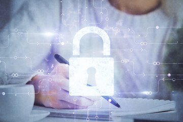 Double exposure of woman's hands writing with lock icon. Concept of security and protection of data