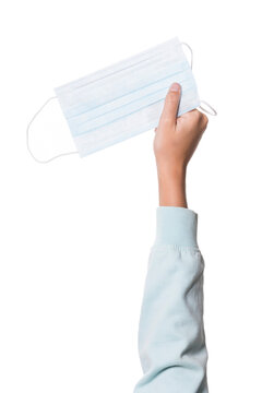 child's hand holding a mask, white background