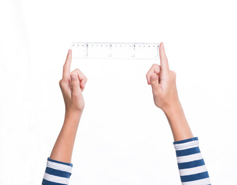 child's hand holding a ruler, white background