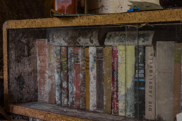 old moldy books in a glass display case