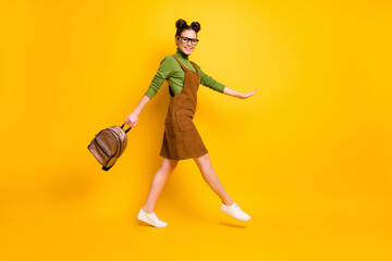 Fototapeta na wymiar Full length body size profile side view of her she attractive cheery intellectual girl nerd jumping going back to school new grade semester isolated bright vivid shine vibrant yellow color background