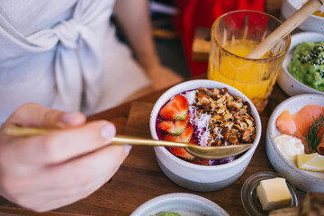 Selective focus on organic homemade sweet dessert with fresh strawberry on cafe table, copped female visitor ordered delicious nutrition food for tasting during vegetarian lunch keep healthy lifestyle