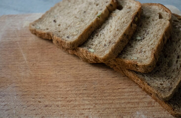 
Bread lies on a kitchen board and spikelets of wheat