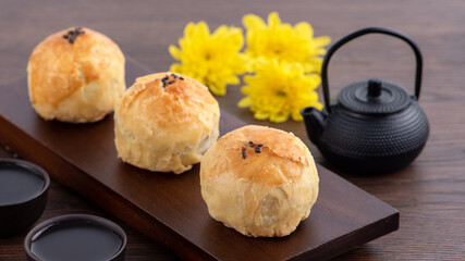Moon cake yolk pastry, mooncake for Mid-Autumn Festival holiday, close up design concept on dark wooden table background