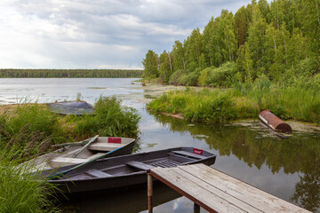 Boats at the pier on the Beloyarsk reservoir near the recreation center