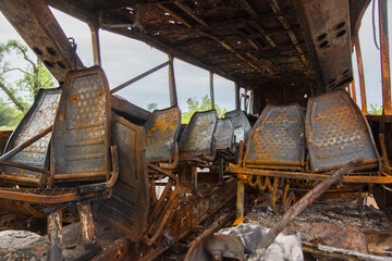 Bombed and burnt bus after shelling. War in Donbass. Eastern Ukraine.