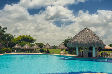 Outdoor resort Swimming pool of luxury hotel in summer spa near the sea. Tropical Paradise. Dominican Republic, Seychelles, Caribbean, Bahamas.