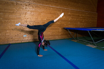 young gymnast in a toss on the sports field