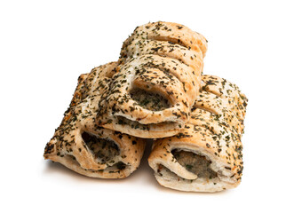 Sausage meat in puff pastry topped with herbs isolated on white