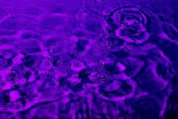 splash of water in lilac light. Abstract wallpaper