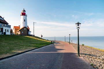 Urk Netherlands harbor and lighthouse near the beach on a bright summer day Flevoland Urk Netherlands Europe - obrazy, fototapety, plakaty