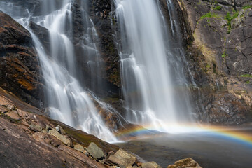 Skjervsfossen waterfall, on the road between Granvin and Voss, Hordaland, Norway. Impressive beautiful win falls plunging 150 metres in a narrow canyon