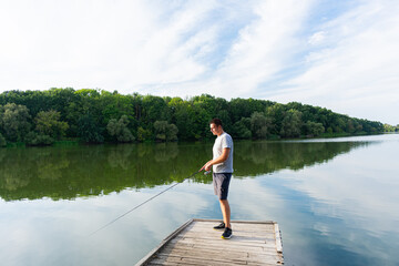 Fototapeta na wymiar Young man fishing in the river