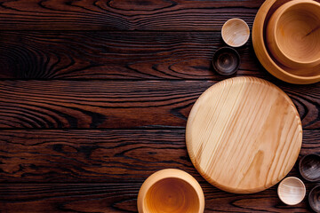 Making wooden dishes. Empty bowls on brown wooden background top view copy space