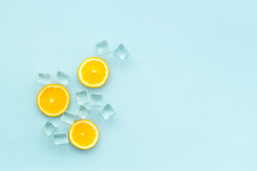 Orange lemonade and iceon blue background