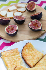 Top view of the Breakfast table with ripe figs, curd casserole and cheese slices. Healthy and delicious food