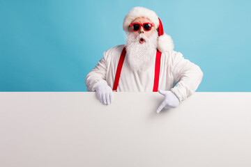 Fototapeta na wymiar Portrait of his he nice attractive funky amazed wondered white-haired Santa demonstrating copy space board advert ad look idea solution isolated over bright vivid shine vibrant blue color background