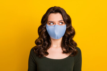 Close-up portrait of her she nice attractive minded wavy-haired girl wearing safety reusable textile mask medicine health care pandemia isolated bright vivid shine vibrant yellow color background