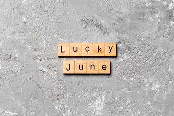 lucky June word written on wood block. Happy June text on table, concept